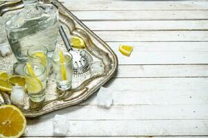 Vodka shots with lemon and ice. photo