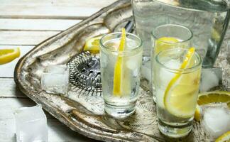 Vodka shots with lemon and ice. photo