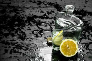 Vodka in glasses with lemon and ice. photo