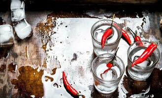 Vodka shots with chili pepper. photo