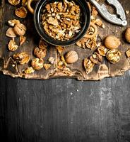 Shelled walnuts in bowl with Nutcracker. photo