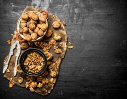 Shelled walnuts in bowl with Nutcracker. photo