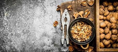 Shelled walnuts in bowl with Nutcracker photo