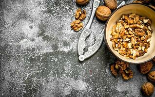 Shelled walnuts in bowl with Nutcracker photo