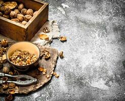 Shelled walnuts in bowl with Nutcracker photo