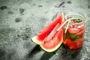 Watermelon juice with mint in glass jar. photo