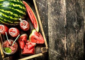 Cocktail of fresh watermelons in bottles. photo