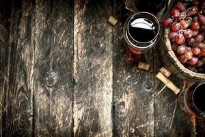 Red wine with a bucket of grapes. photo