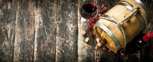 Wine background. A barrel with red wine and freshly grapes. photo