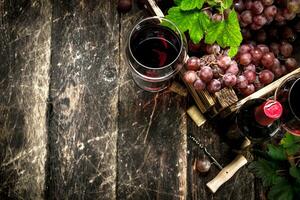 Wine background. Red wine with a box of grapes. photo