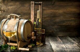 Wine background. A barrel of white wine with branches of green grapes. photo