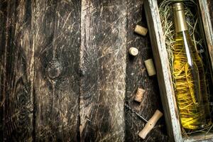 White wine in old box with green grapes. photo