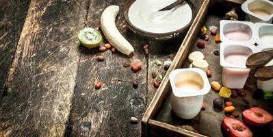 Fresh yogurts with fruits and nuts. photo