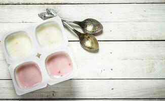 Fruit yogurt with spoons. photo