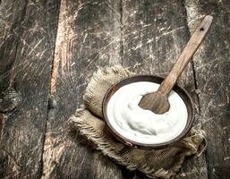 Natural yogurt in a bowl. photo