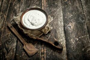 Natural yogurt in a bowl. photo