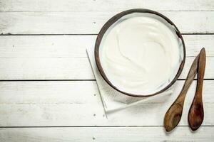 Natural yogurt in a bowl. photo