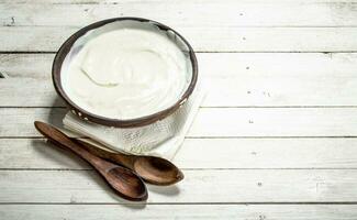 Natural yogurt in a bowl. photo