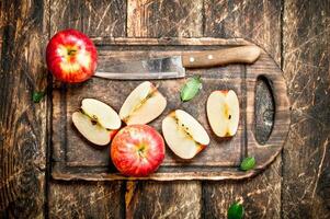 Fresh apples on a cutting Board with a knife. photo