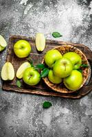 Fresh green apples on a cutting Board. photo