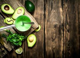 Fresh avocado sauce, lime and herbs. photo