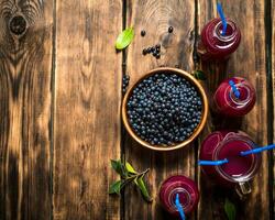 Blueberry juice . On wooden table. photo