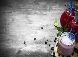 Blueberry smoothies and fresh juice on the old fabric. photo