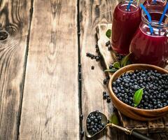 Blueberry juice . On wooden table. photo