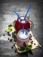 Blueberry smoothies and fresh juice on the old fabric. photo