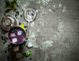 Fresh blueberry shake with ice. On stone background. photo