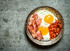 fresh Breakfast. Fried bacon with eggs and red beans. photo