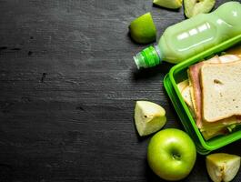 Morning picnic. Sandwiches milkshake and fruit. photo