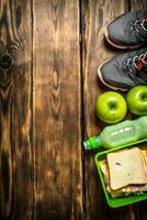 Sandwiches , fruit ,milkshake and sports sneakers photo