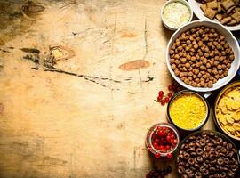 Cereal in cups. On wooden background. photo