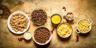 Cereal in cups. On wooden background. photo