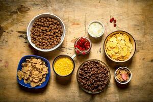 Cereal in cups. On wooden background. photo