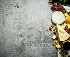 Pieces of cheese with red wine and nuts. photo
