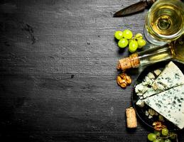 bottle white wine with slice of cheese photo