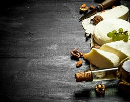 White wine with goat cheese, grapes and nuts. photo