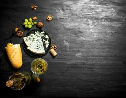 White wine with French blue cheese and nuts. photo