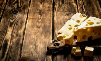 Pieces of fresh cheese on cutting Board. photo