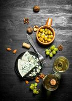 Italian white wine, aromatic cheese and walnuts. photo