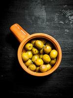 Canned olives in a bowl. photo