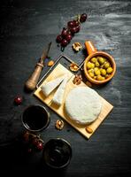 Sheep cheese with red wine , nuts and olives. photo