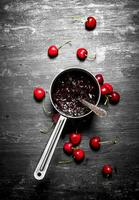 Cherry jam in a saucepan. photo