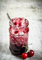 The jar with the cherry jam. photo