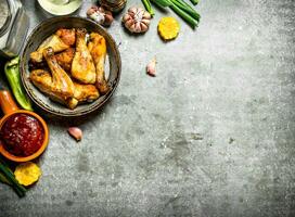 Fried chicken with vegetables and tomato sauce. photo