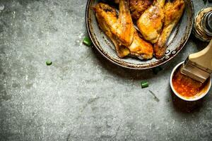 Fried chicken legs with tomato sauce. photo