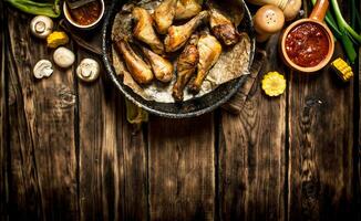 Fried chicken legs with tomato sauce. photo