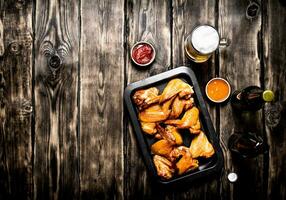 Smoked chicken wings with beer photo